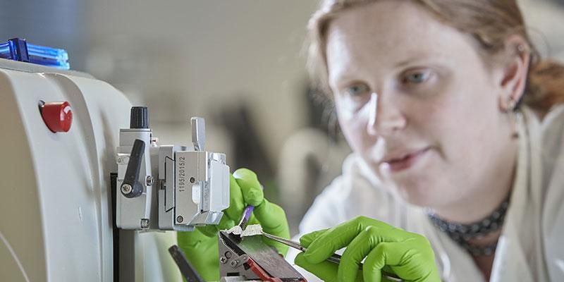 A postgraduate researcher using engineering technology in a laboratory.