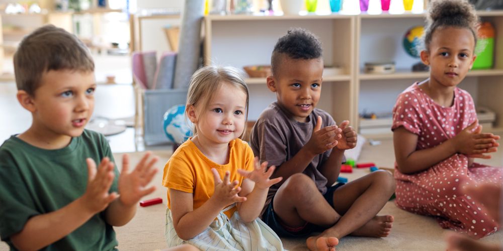 Young children clapping in an Early Childhood Education and Care setting
