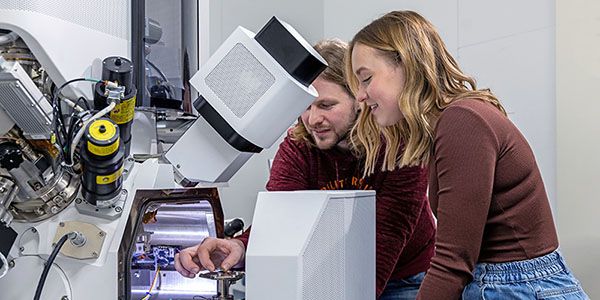 Researchers operating a large device