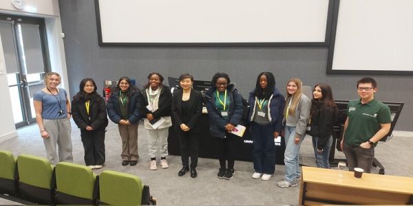 Students and Professor Xiaowei Zhuang smile at the camera at the Astbury Conversation