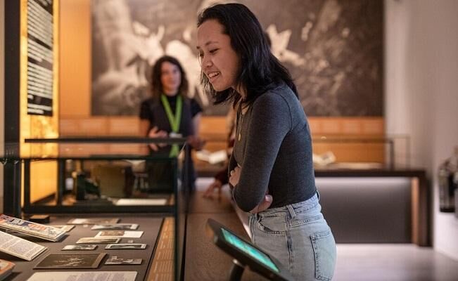 Student looking at items in the Treasures of the Brotherton Gallery