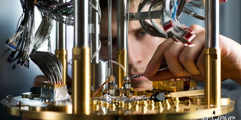 Quantum computer with shining silver and gold pipes and bundles of wires, with a man in the background, adjusting one of the computer parts. 