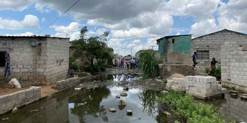 An informal community settlement near Lusaka in Zambia showing the after-effects of flash flooding which has rendered the street impassable.