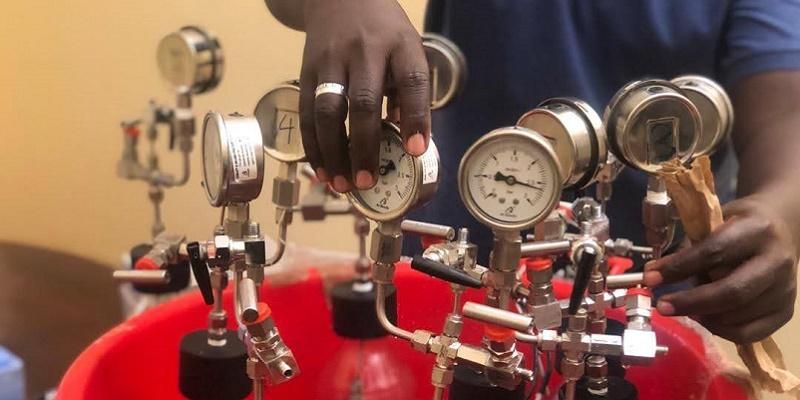A researcher in Uganda carrying out experiments to produce biogas from water hyacinth
