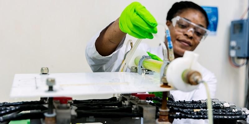 A scientist adjusts equipment in a nuclear engineering lab