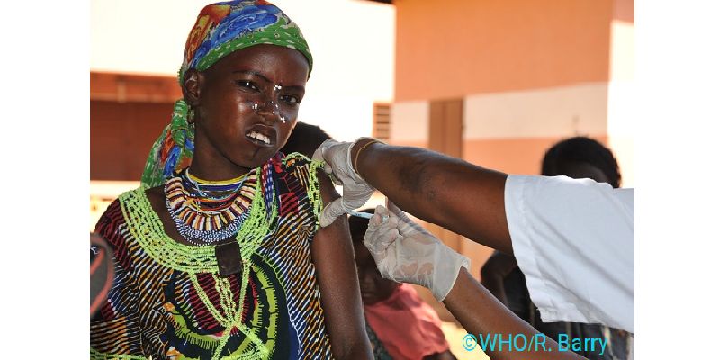 The image shows a woman being vaccinated against meningitis. Picture is courtesy of the World Health Organisation