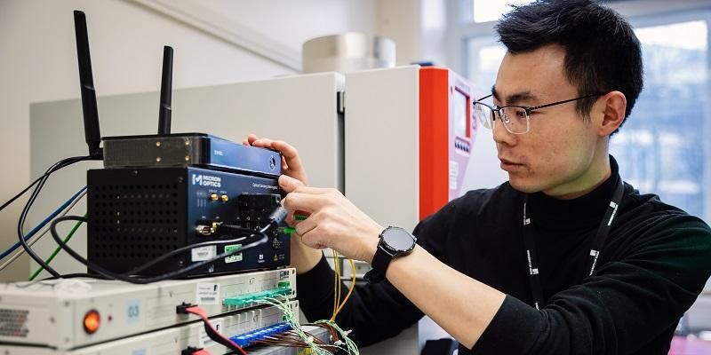 A scientist adjusts equipment in a smart energy lab