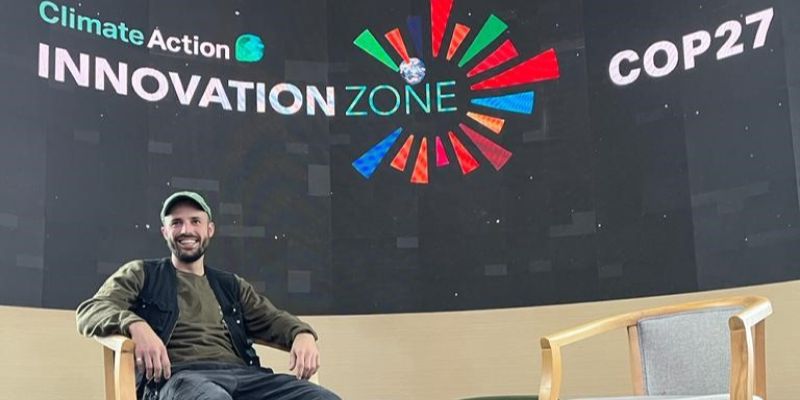 Théo Grainzevelles sits on the stage at COP27