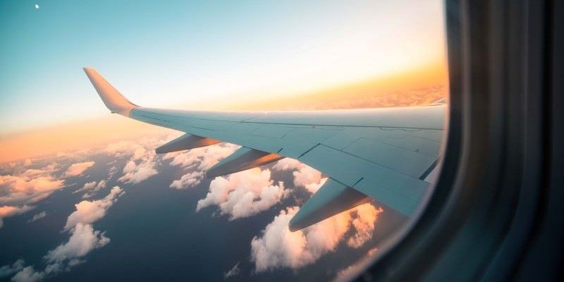 The wing of a plane seen through the plane's window