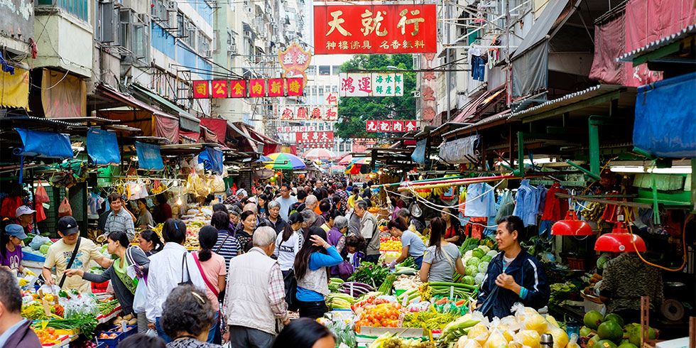 People shopping at a busy food market.